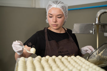 Artisanal chocolate production at Steiner & Kovarik—handcrafting white chocolate truffles using traditional methods in a professional kitchen.